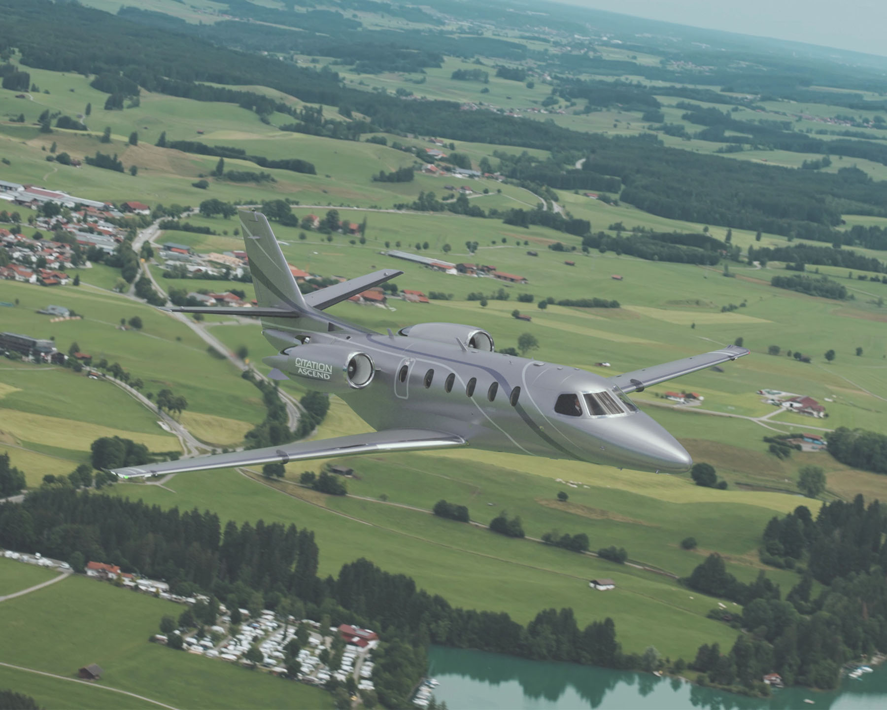 Citation Ascend flying over the European countryside.