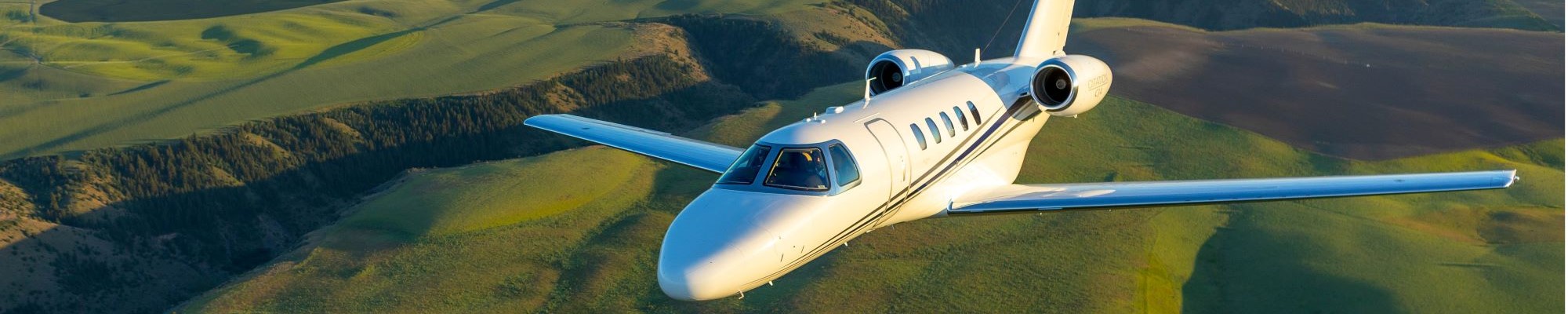 Cessna Citation CJ4 flying over field, close up view of Windshield Assembly Left and Windshield Assembly Right